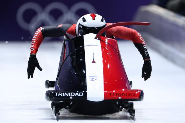 TOPSHOT - Trinidad and Tobago's Axel Brown and Trinidad and Tobago's De Aundre John compete in the bobsleigh men's 2-man heat 1 at Cortina Sliding Centre during the Milano Cortina 2026 Winter Olympic Games in Cortina d'Ampezzo on February 16, 2026. (Photo by FRANCK FIFE / AFP)