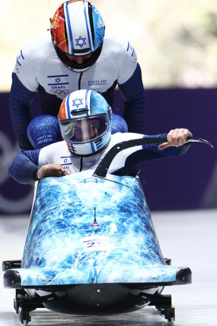 Israel's Adam Edelman and Israel's Menachem Chen compete in the bobsleigh men's 2-man heat 1 at Cortina Sliding Centre during the Milano Cortina 2026 Winter Olympic Games in Cortina d'Ampezzo on February 16, 2026. (Photo by FRANCK FIFE / AFP)