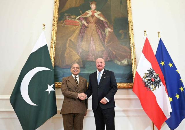 Austria's Chancellor Christian Stocker (R) shakes hands with Pakistan's Prime Minister Shehbaz Sharif prior a meeting during an official visit to Vienna, Austria on February 16, 2026. (Photo by HELMUT FOHRINGER / various sources / AFP) / Austria OUT