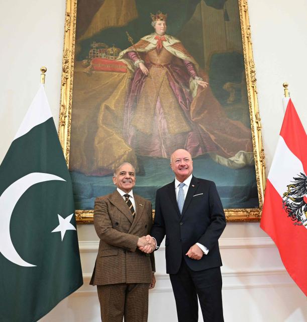 Austria's Chancellor Christian Stocker (R) shakes hands with Pakistan's Prime Minister Shehbaz Sharif prior a meeting during an official visit to Vienna, Austria on February 16, 2026. (Photo by HELMUT FOHRINGER / various sources / AFP) / Austria OUT