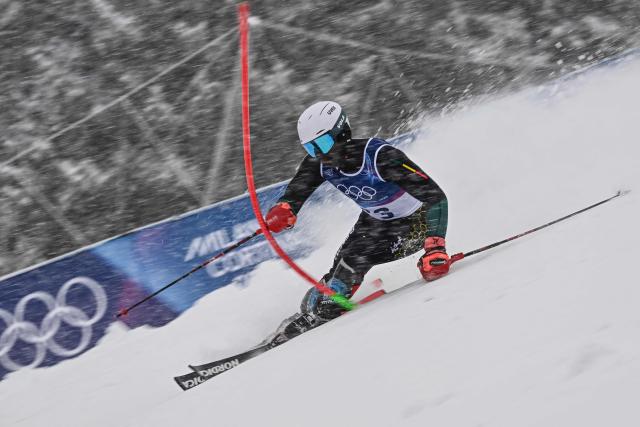 Benin's Nathan Tchibozo competes in the first run of the men's slalom alpine skiing event during the Milano Cortina 2026 Winter Olympic Games at the Stelvio Ski Centre in Bormio (Valtellina) on February 16, 2026. (Photo by Fabrice COFFRINI / AFP)