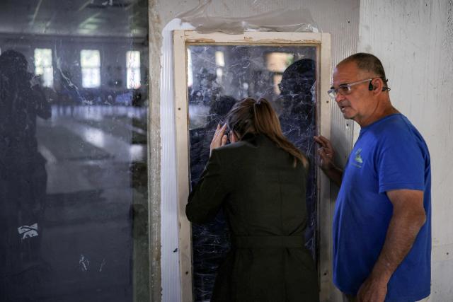 Aurore Berge, France's junior Minister in charge of equality, looks through a glass pane as she tours Kibbutz Nir Oz, one of the sites of the 2023 October 7 attacks, in southern Israel on February 16, 2026. (Photo by Ilia YEFIMOVICH / AFP)