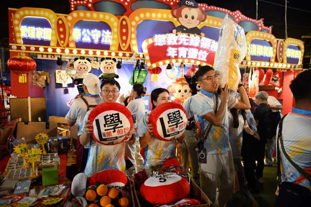 People attend a Lunar New Year fair in Victoria Park on the eve of the Lunar New Year of the Horse in Hong Kong on February 16, 2026. (Photo by Peter PARKS / AFP)