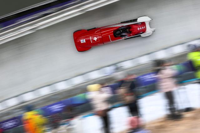 Switzerland's Timo Rohner and Switzerland's Tim Annen  compete in the bobsleigh men's 2-man heat 2 at Cortina Sliding Centre during the Milano Cortina 2026 Winter Olympic Games in Cortina d'Ampezzo on February 16, 2026. (Photo by FRANCK FIFE / AFP)