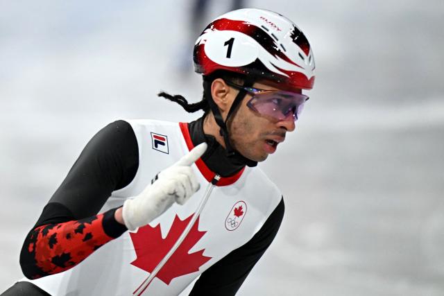 Canada's William Dandjinou reacts after qualifying to the final in the short track speed skating men's 5000m relay semi-final during the Milano Cortina 2026 Winter Olympic Games at Milano Ice Skating Arena in Milan on February 16, 2026. (Photo by Gabriel BOUYS / AFP)