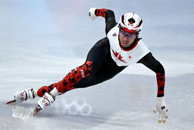 Canada's William Dandjinou competes in the short track speed skating men's 5000m relay semi-final during the Milano Cortina 2026 Winter Olympic Games at Milano Ice Skating Arena in Milan on February 16, 2026. (Photo by WANG Zhao / AFP)