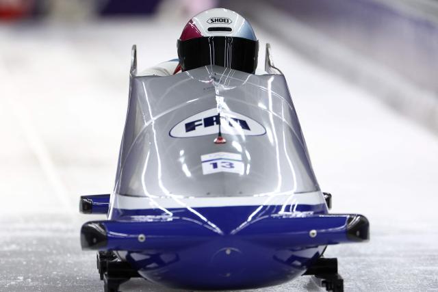 France's Romain Heinrich and France's Dorian Hauterville compete in the bobsleigh men's 2-man heat 1 at Cortina Sliding Centre during the Milano Cortina 2026 Winter Olympic Games in Cortina d'Ampezzo on February 16, 2026. (Photo by FRANCK FIFE / AFP)