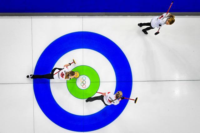 Canada's Sarah Wilkes (L), Canada's Emma Miskew (C) and Canada's Tracy Fleury (R) compete in the curling women's round robin between China and Canada during the Milano Cortina 2026 Winter Olympic Games at the Cortina Curling Olympic Stadium in Cortina d’Ampezzo on February 16, 2026. (Photo by Odd ANDERSEN / AFP)