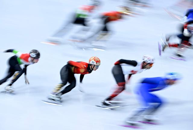 China's Li Wenlong competes in the short track speed skating men's 5000m relay semi-final during the Milano Cortina 2026 Winter Olympic Games at Milano Ice Skating Arena in Milan on February 16, 2026. (Photo by WANG Zhao / AFP)