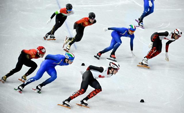 Canada's Felix Roussel, Italy's Thomas Nadalini and China's Lin Xiaojun compete in the short track speed skating men's 5000m relay semi-final during the Milano Cortina 2026 Winter Olympic Games at Milano Ice Skating Arena in Milan on February 16, 2026. (Photo by WANG Zhao / AFP)