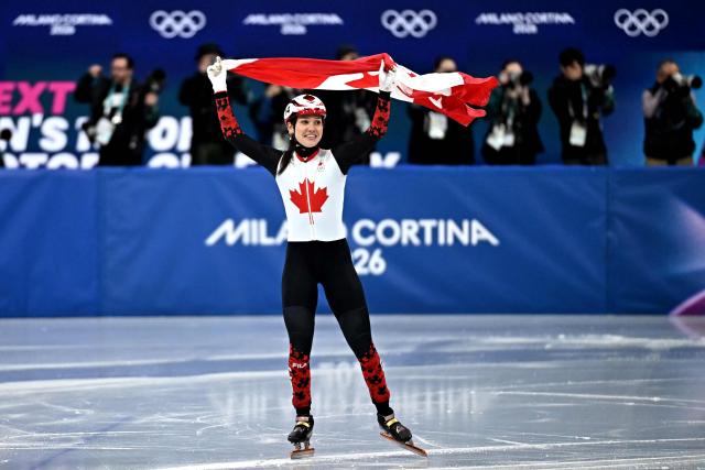 Canada's Courtney Sarault celebrates after winning silver in the short track speed skating women's 1000m final during the Milano Cortina 2026 Winter Olympic Games at Milano Ice Skating Arena in Milan on February 16, 2026. (Photo by Gabriel BOUYS / AFP)