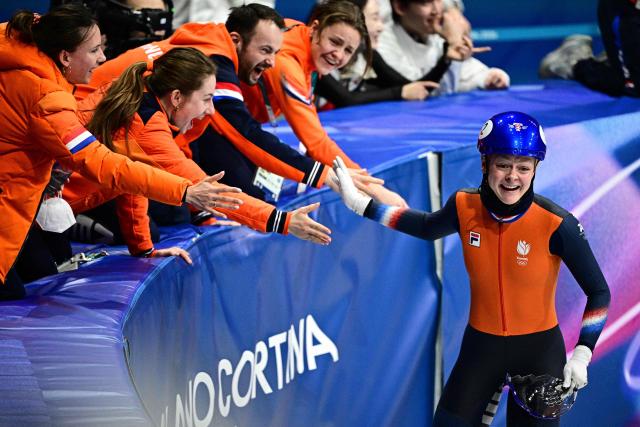 Netherlands' Xandra Velzeboer celebrates with her team after winning gold in the short track speed skating women's 1000m final during the Milano Cortina 2026 Winter Olympic Games at Milano Ice Skating Arena in Milan on February 16, 2026. (Photo by JULIEN DE ROSA / AFP)