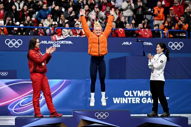 Gold medallist Netherlands' Xandra Velzeboer jumps on the podium of the short track speed skating women's 1000m final during the Milano Cortina 2026 Winter Olympic Games at Milano Ice Skating Arena in Milan on February 16, 2026. (Photo by Gabriel BOUYS / AFP)