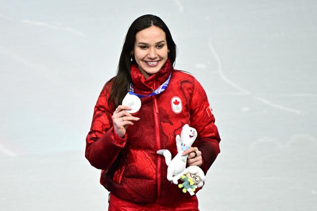 Silver medallist Canada's Courtney Sarault poses on the podium of the short track speed skating women's 1000m final during the Milano Cortina 2026 Winter Olympic Games at Milano Ice Skating Arena in Milan on February 16, 2026. (Photo by JULIEN DE ROSA / AFP)