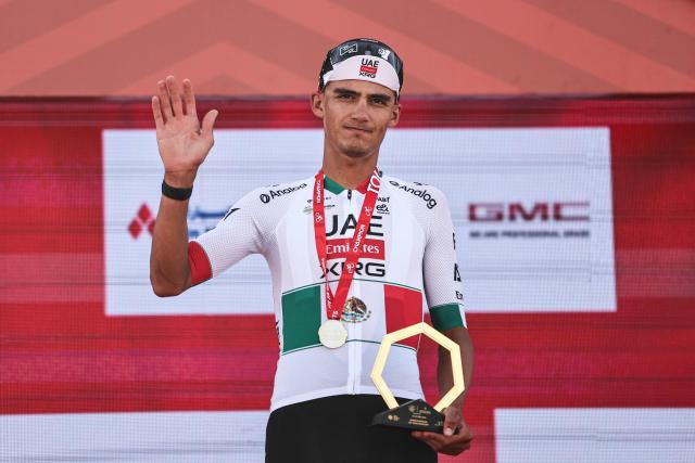 UAE Team Emirates's Mexican rider Isaac Del Toro Romero celebrates with his trophy after winning the first stage of the UAE Tour cycling event from Madinat Zayed Majlis to Liwa Palace in Abu Dhabi on February 16, 2026. (Photo by Fadel SENNA / AFP)