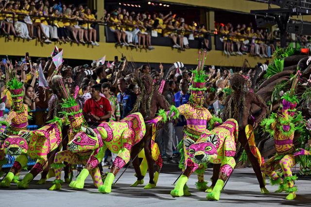 Revellers of the Mangueira samba school perform during the opening night of the Rio Carnival at the Marques de Sapucai Sambadrome in Rio de Janeiro, Brazil, on February 16, 2026. (Photo by Pablo PORCIUNCULA / AFP)