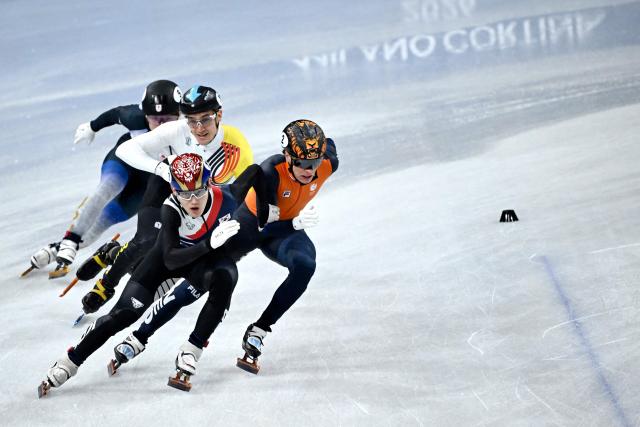 (From front) South Korea's Rim Jong-un, Netherlands' Jens van 't Wout, Belgium's Stijn Desmet and Japan's Shogo Miyata compete in the short track speed skating men's 5000m relay semi-final during the Milano Cortina 2026 Winter Olympic Games at Milano Ice Skating Arena in Milan on February 16, 2026. (Photo by WANG Zhao / AFP)