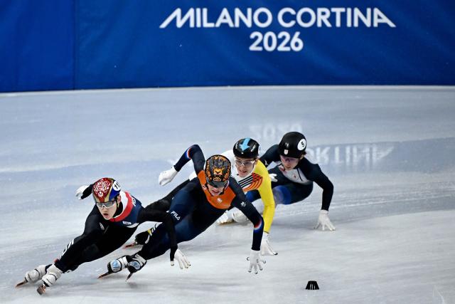 (From L) South Korea's Rim Jong-un, Netherlands' Jens van 't Wout, Belgium's Stijn Desmet and Japan's Shogo Miyata compete in the short track speed skating men's 5000m relay semi-final during the Milano Cortina 2026 Winter Olympic Games at Milano Ice Skating Arena in Milan on February 16, 2026. (Photo by WANG Zhao / AFP)
