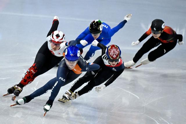 Netherlands' Xandra Velzeboer (2nd L), Canada's Courtney Sarault (L) and South Korea's Kim Gil-li (2nd R) compete for gold, silver and bronze respectively in the short track speed skating women's 1000m final during the Milano Cortina 2026 Winter Olympic Games at Milano Ice Skating Arena in Milan on February 16, 2026. (Photo by WANG Zhao / AFP)