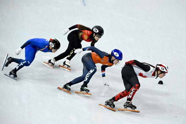 Italy's Arianna Fontana, China's Gong Li, Netherlands' Xandra Velzeboer and Canada's Courtney Sarault compete in the short track speed skating women's 1000m final during the Milano Cortina 2026 Winter Olympic Games at Milano Ice Skating Arena in Milan on February 16, 2026. (Photo by WANG Zhao / AFP)