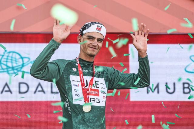 UAE Team Emirates's Mexican rider Isaac Del Toro Romero celebrates on the podium after winning the first stage of the UAE Tour cycling event from Madinat Zayed Majlis to Liwa Palace in Abu Dhabi on February 16, 2026. (Photo by Fadel SENNA / AFP)