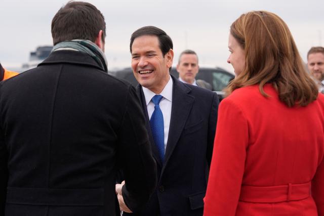 US Secretary of State Marco Rubio (C) talks to Hungary's Deputy Foreign Minister Levente Magyar and Chargй d’Affaires of the US Mission to Hungary Caroline Savage as he departs at the Liszt Ferenc International Airport in Budapest, Hungary, on February 16, 2026. (Photo by Alex Brandon / POOL / AFP)