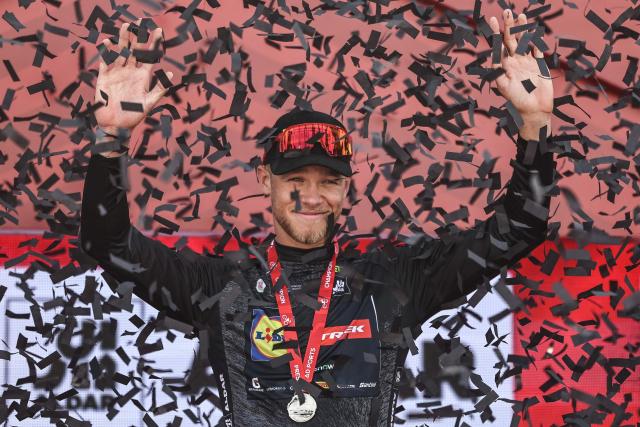 Lidl-Trek's Italian rider Jonathan Milan celebrates on the podium as intermediate sprinter jersey winner at the end of the first stage of the UAE Tour cycling event from Madinat Zayed Majlis to Liwa Palace in Abu Dhabi on February 16, 2026. (Photo by Fadel SENNA / AFP)
