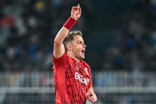 England's Sam Curran celebrates after taking the wicket of Italy's Gian-Piero Meade during the 2026 ICC Men's T20 Cricket World Cup group stage match between England and Italy at the Eden Gardens in Kolkata on February 16, 2026. (Photo by Dibyangshu SARKAR / AFP)