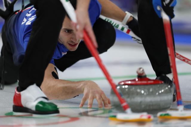Italy's Sebastiano Arman delivers the stone in the curling men's round robin between Italy and China during the Milano Cortina 2026 Winter Olympic Games at the Cortina Curling Olympic Stadium in Cortina d’Ampezzo on February 16, 2026. (Photo by Odd ANDERSEN / AFP)