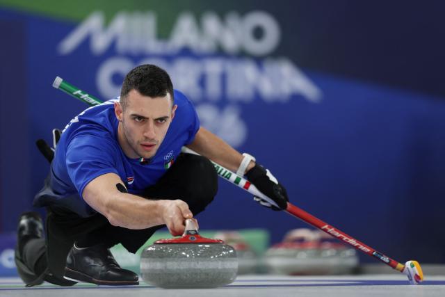 Italy's Sebastiano Arman delivers the stone during the curling men's round robin between Italy and China during the Milano Cortina 2026 Winter Olympic Games at the Cortina Curling Olympic Stadium in Cortina d’Ampezzo on February 16, 2026. (Photo by Odd ANDERSEN / AFP)