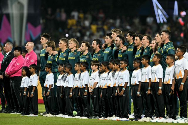 Australia's team players stand for the national anthem before the start of the 2026 ICC Men's T20 Cricket World Cup group stage match between Australia and Sri Lanka at Pallekele International Cricket Stadium in Kandy on February 16, 2026. (Photo by Ishara S. KODIKARA / AFP)