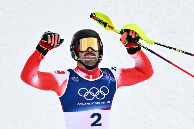 Switzerland's Loic Meillard celebrates after winning the men's slalom alpine skiing event during the Milano Cortina 2026 Winter Olympic Games at the Stelvio Ski Centre in Bormio (Valtellina) on February 16, 2026. (Photo by Fabrice COFFRINI / AFP)