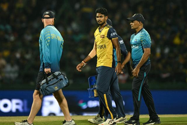 Sri Lanka's Matheesha Pathirana (C) walks back to the pavilion after suffering a leg injury during the 2026 ICC Men's T20 Cricket World Cup group stage match between Australia and Sri Lanka at Pallekele International Cricket Stadium in Kandy on February 16, 2026. (Photo by Ishara S. KODIKARA / AFP)