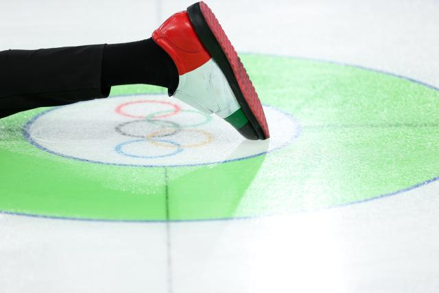 A picture shows the Italian-themed shoe of Italy's Mattia Giovanella during the curling men's round robin between Italy and China during the Milano Cortina 2026 Winter Olympic Games at the Cortina Curling Olympic Stadium in Cortina d’Ampezzo on February 16, 2026. (Photo by Odd ANDERSEN / AFP)