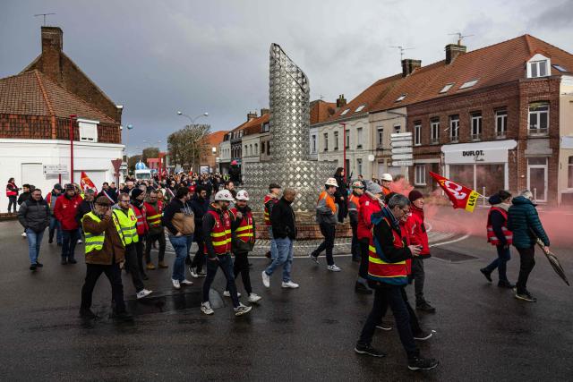 Protesters take part in a rally on the eve of the formal submission of takeover offers for glassmaking giant Arc in Arques, northern France, on February 16, 2026. Around 500 Arc employees and political figures demonstrated in Arques (Pas-de-Calais) on February 16, 2026, on the eve of the deadline for submitting takeover bids for the glassmaker, which was placed in receivership in early January. (Photo by Sameer Al-DOUMY / AFP)