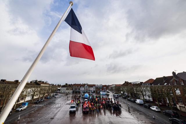 Protesters take part in a rally on the eve of the formal submission of takeover offers for glassmaking giant Arc in Arques, northern France on February 16, 2026. Around 500 Arc employees and political figures demonstrated in Arques (Pas-de-Calais) on February 16, 2026, on the eve of the deadline for submitting takeover bids for the glassmaker, which was placed in receivership in early January. (Photo by Sameer Al-DOUMY / AFP)
