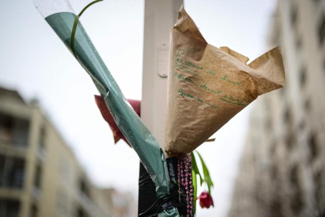A bouquet of flowers hangs at the site of the brawl that caused the death of Quentin Deranque, a far-right activist a who died after a fatal beating, in Lyon on February 16, 2026. Quentin Deranque, 23, died of his wounds after being attacked on February 12, 2026 on the sidelines of a far-right protest against a left-wing politician speaking at a university in the city of Lyon. The incident has fuelled tension between France's far right and hard left ahead of municipal elections in March and the 2027 presidential race. (Photo by OLIVIER CHASSIGNOLE / AFP)