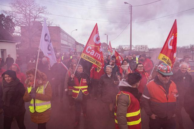 Protesters take part in a rally on the eve of the formal submission of takeover offers for glassmaking giant Arc in Arques, northern France, on February 16, 2026. Around 500 Arc employees and political figures demonstrated in Arques (Pas-de-Calais) on February 16, 2026, on the eve of the deadline for submitting takeover bids for the glassmaker, which was placed in receivership in early January. (Photo by Sameer Al-DOUMY / AFP)