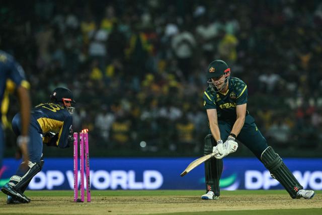 Australia's Cameron Green (R) is stumped out by Sri Lanka's wicketkeeper Kusal Mendis during the 2026 ICC Men's T20 Cricket World Cup group stage match between Australia and Sri Lanka at Pallekele International Cricket Stadium in Kandy on February 16, 2026. (Photo by Ishara S. KODIKARA / AFP)