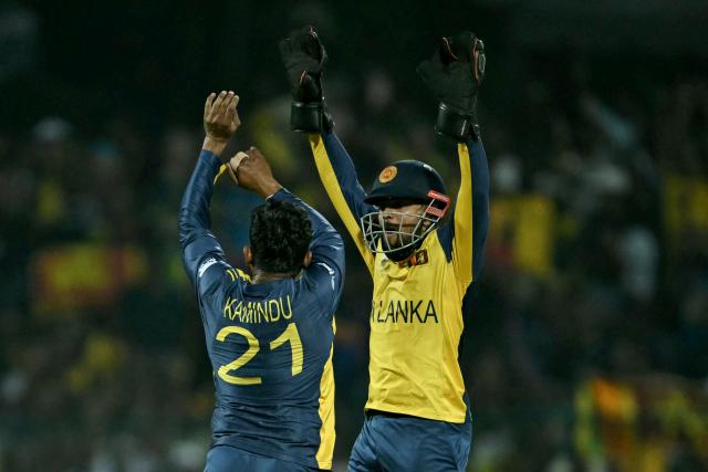Sri Lanka's Kamindu Mendis (L) celebrates with wicketkeeper Kusal Mendis after taking the wicket of Australia's Tim David during the 2026 ICC Men's T20 Cricket World Cup group stage match between Australia and Sri Lanka at Pallekele International Cricket Stadium in Kandy on February 16, 2026. (Photo by Ishara S. KODIKARA / AFP)