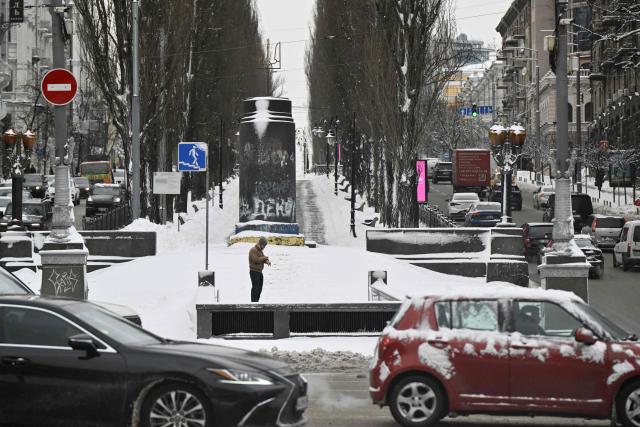Cars drive along a snow-covered road in central Kyiv following overnight snowfall on February 16, 2026, amid the Russian invasion of Ukraine. (Photo by Genya SAVILOV / AFP)