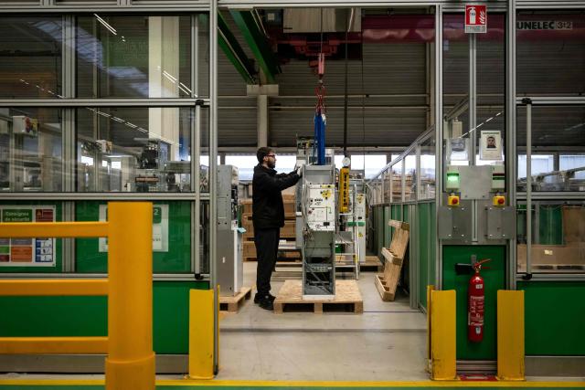 An employee works on a production line at the Schneider Electric site in Macon, central-eastern France, on February 16, 2026. (Photo by ARNAUD FINISTRE / AFP)