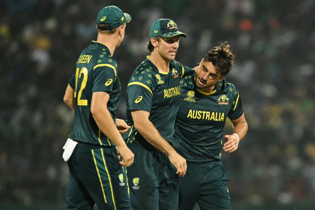 Australia's Marcus Stoinis (R) celebrates with captain Mitchell Marsh (C) and Cameron Green after taking the wicket of Sri Lanka's Kusal Mendis during the 2026 ICC Men's T20 Cricket World Cup group stage match between Australia and Sri Lanka at Pallekele International Cricket Stadium in Kandy on February 16, 2026. (Photo by Ishara S. KODIKARA / AFP)