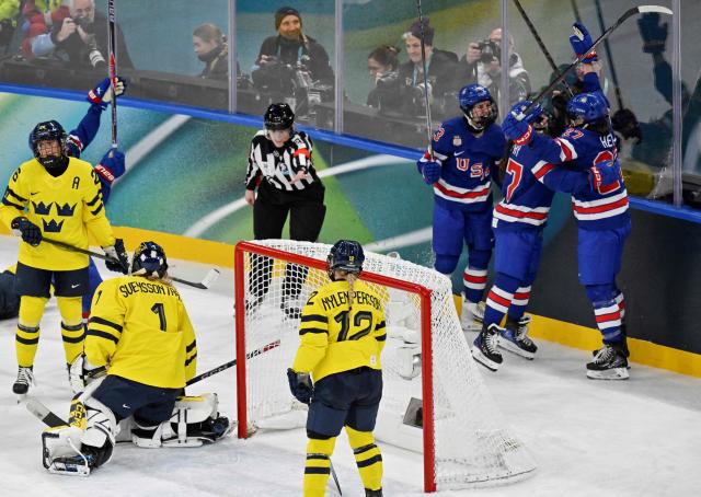 USA's forward #27 Taylor Heise (2nd R) celebrates with teammates after scoring her team's second goal during the women's play-off semi-final ice hockey match between USA and Sweden at the Milano Santagiulia Ice Hockey Arena during the Milano Cortina 2026 Winter Olympic Games in Milan, on February 16, 2026. (Photo by Alexander NEMENOV / AFP)