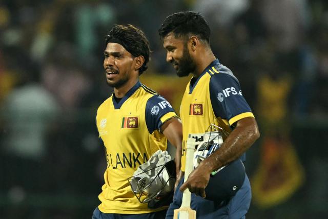 Sri Lanka's Pathum Nissanka (L) and Pavan Rathnayake walk back to the pavilion as they celebrate their team's win against Australia at the end of their 2026 ICC Men's T20 Cricket World Cup group stage match in the Pallekele International Cricket Stadium, Kandy on February 16, 2026. (Photo by Ishara S. KODIKARA / AFP)