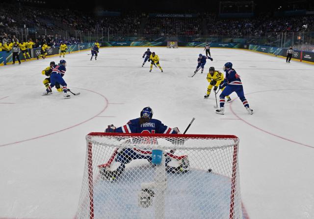USA's goalkeeper #31 Aerin Frankel (C) makes a save during the women's play-off semi-final ice hockey match between USA and Sweden at the Milano Santagiulia Ice Hockey Arena during the Milano Cortina 2026 Winter Olympic Games in Milan, on February 16, 2026. (Photo by Alexander NEMENOV / POOL / AFP)