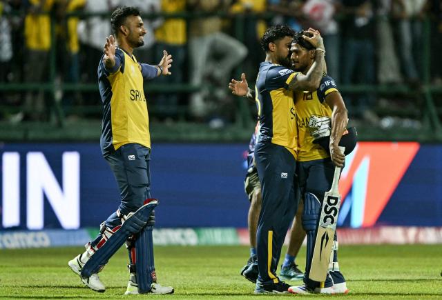 Sri Lanka's Pathum Nissanka (R) is congratulated by Kusal Mendis (C) and captain Dasun Shanaka for his innings as they celebrate their team's win against Australia at the end of their 2026 ICC Men's T20 Cricket World Cup group stage match in the Pallekele International Cricket Stadium, Kandy on February 16, 2026. (Photo by Ishara S. KODIKARA / AFP)