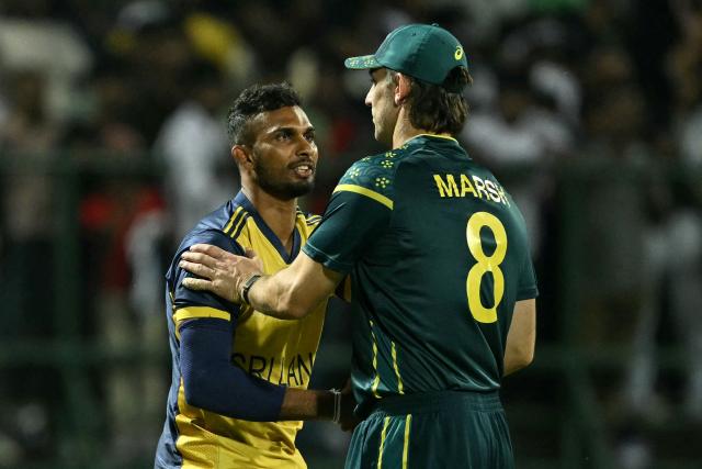 Sri Lanka's captain Dasun Shanaka (L) is congratulated by his Australian counterpart Mitchell Marsh for his team's win at the end of their 2026 ICC Men's T20 Cricket World Cup group stage match in the Pallekele International Cricket Stadium, Kandy on February 16, 2026. (Photo by Ishara S. KODIKARA / AFP)