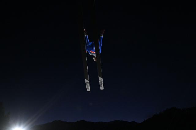 An athlete jumps during the trial round of the men's large hill super team ski jumping of the Milano Cortina 2026 Winter Olympic Games at Predazzo Ski Jumping Stadium in Predazzo (Val di Fiemme), on February 16, 2026. (Photo by Javier SORIANO / AFP)