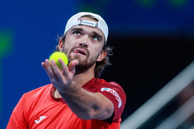 Czech Republic's Tomas Machac serves a ball against Italy's Jannik Sinner during their men’s singles match at the Qatar Open tennis tournament in Doha on February 16, 2026. (Photo by Karim JAAFAR / AFP)